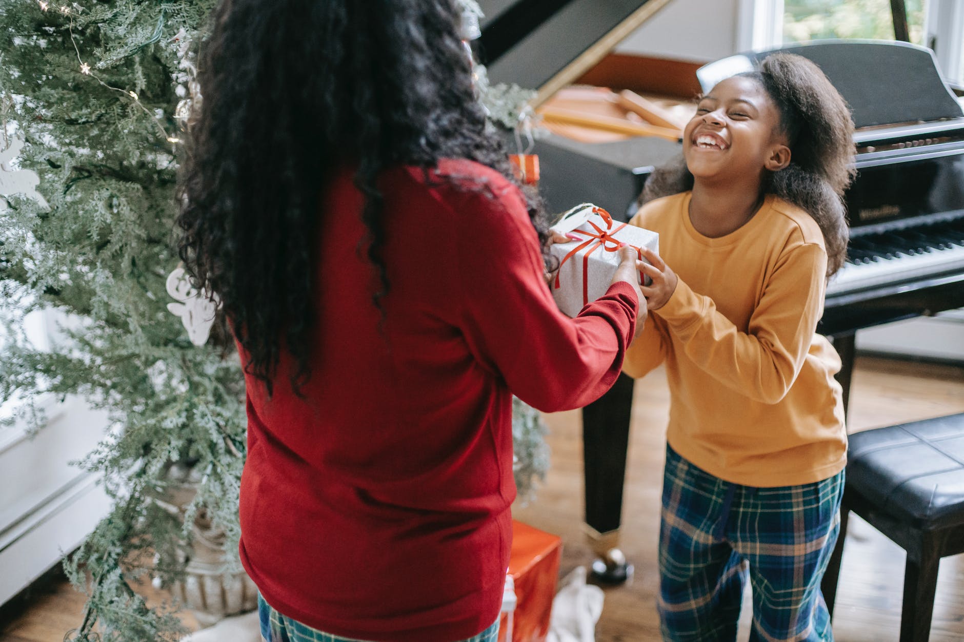 giving christmas present to happy girl