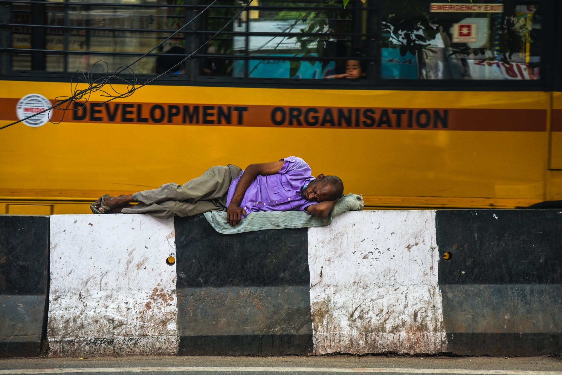 man lying on barricades