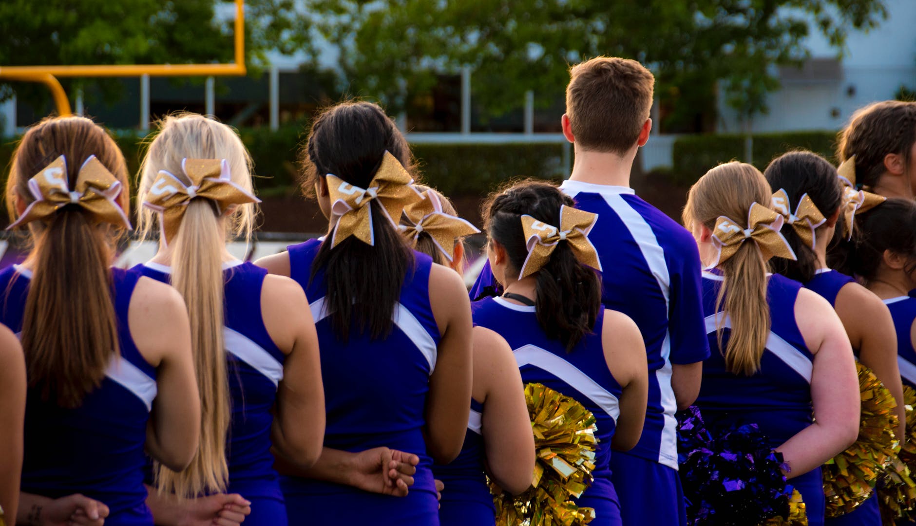 photo of cheerleaders in blue and white uniform